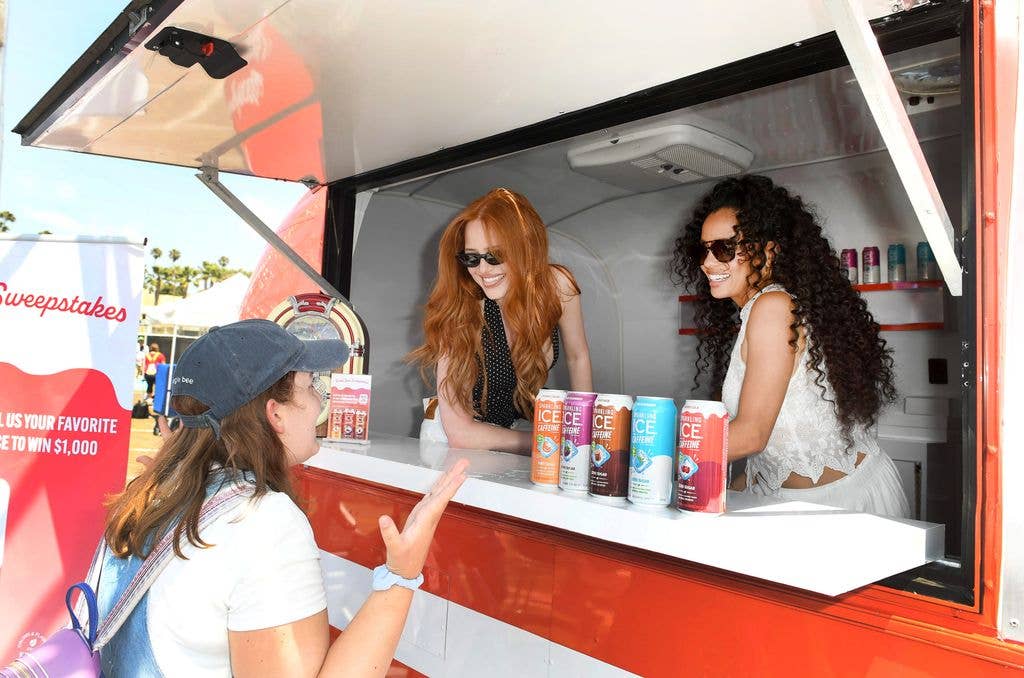 Madelaine Petsch and Vanessa Morgan handing out Sparkling Ice Soda Shoppe to adoring fans on the Santa Monica Pier in LA