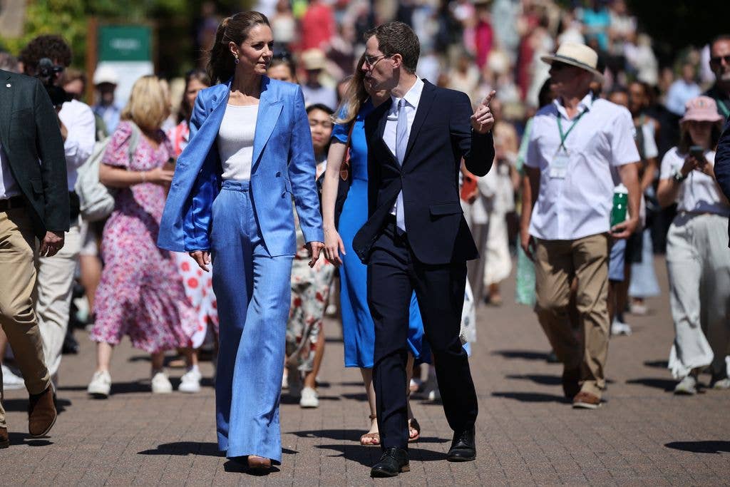 The Princess of Wales in a pastel blue suit with her hair in a ponytail