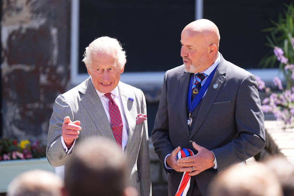 King Charles III starts a traditional game of hand ba' during his visit to Jedburgh in the Scottish Borders