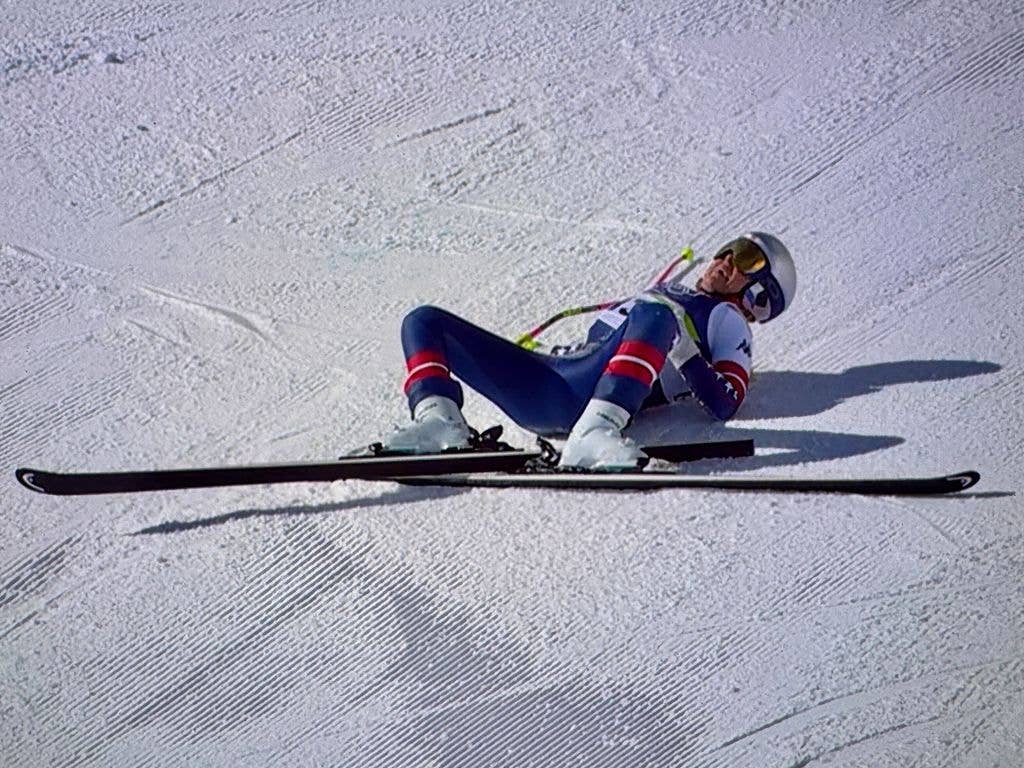 Lindsey Vonn lying on the crowd with her skis after she crashes
