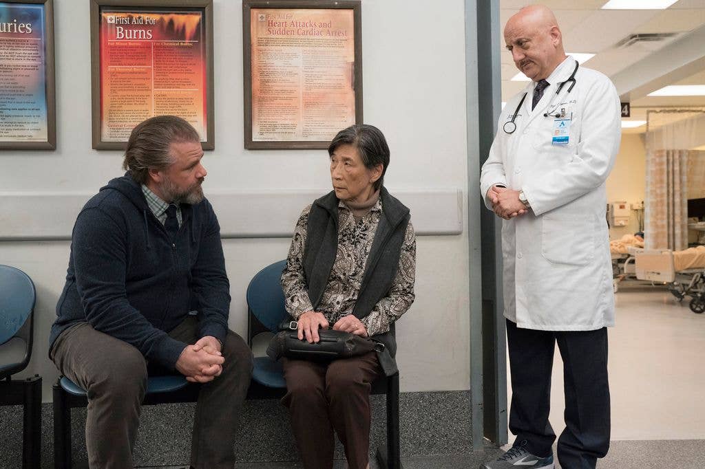 NEW AMSTERDAM -- "Three Dots" Episode 108 -- Pictured: (l-r) Tyler Labine as Dr. Iggy Frome, Wai Ching Ho as June Chiang, Anupam Kher as Dr. Vijay Kapoor