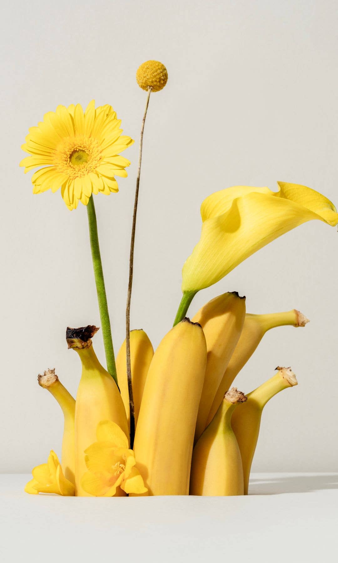 Banana still life with yellow flowers