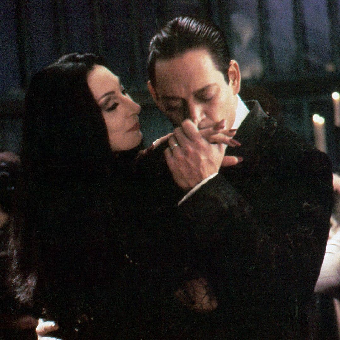 Anjelica Huston is kissed by Raul Julia in a scene from the film 'The Addams Family', 1991