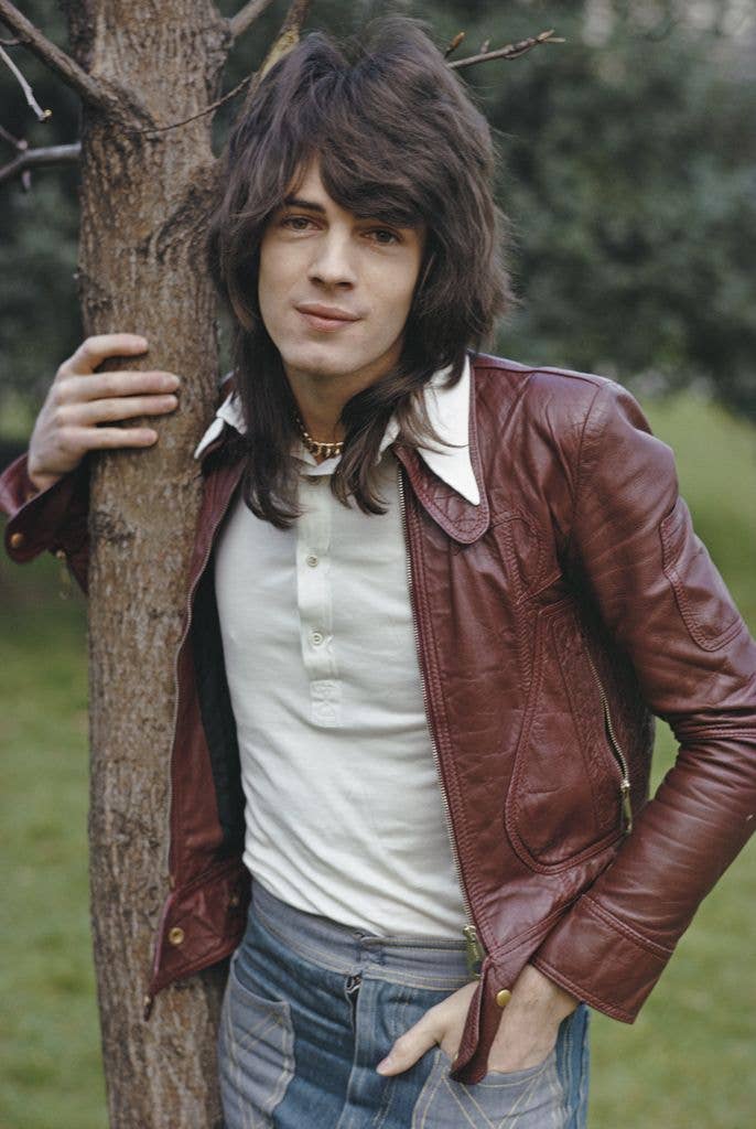 Australian singer-songwriter Rick Springfield pictured wearing a burgundy leather jacket in a park in London in 1973.