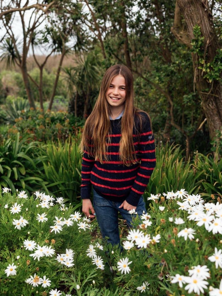 Princess Charlotte poses among white daisies and subtropical vegetation in Cornwall