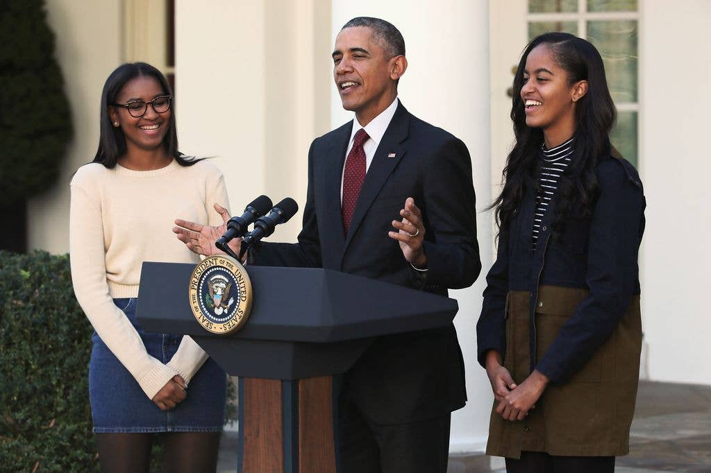 U.S. President Barack Obama delivers remarks with his daughters Sasha (L) and Malia during the annual turkey pardoning ceremony in the Rose Garden at the White House  November 25, 2015 in Washington, DC. In a tradition dating back to 1947, the president pardons a turkey, sparing the tom -- and his alternate -- from becoming a Thanksgiving Day feast. This year, Americans were asked to choose which of two turkeys would be pardoned and to cast their votes on Twitter.