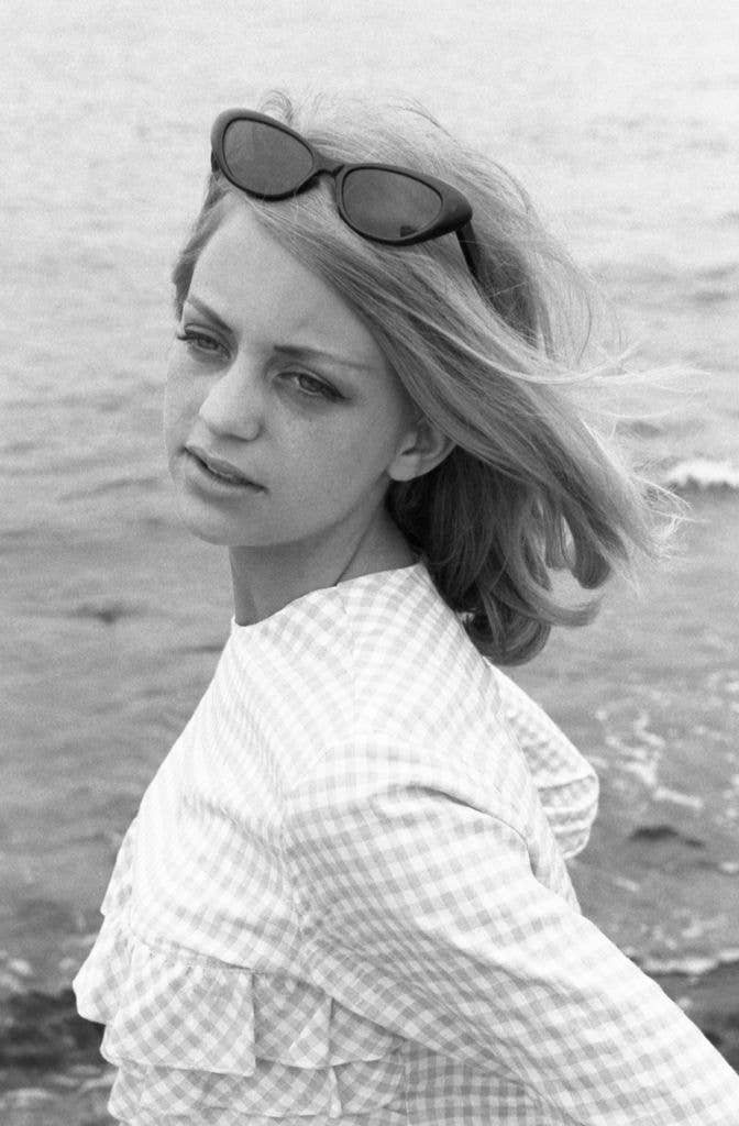 Portrait of American dancer and dance instructor, and future actress, Goldie Hawn, sunglasses on her head, as she poses in a ruffled, gingham top, Washington DC, May 28, 1964.