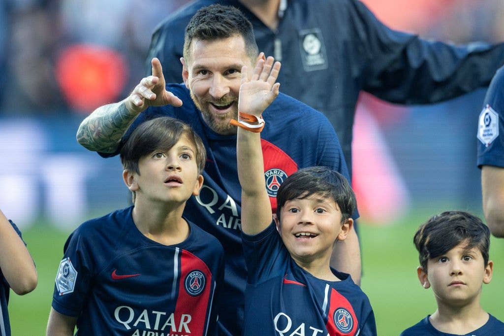Lionel Messi #30 of Paris Saint-Germain with his sons Thiago, Mateo, and Ciro, as they look to spot his wife and the boy's mother Antonela Roccuzzo in the crowd after the players were accompanied by their children for pre-match presentations before the Paris Saint-Germain V Clermont, French Ligue 1 regular season match at Parc des Princes on June 3, 2023, in Paris, France 