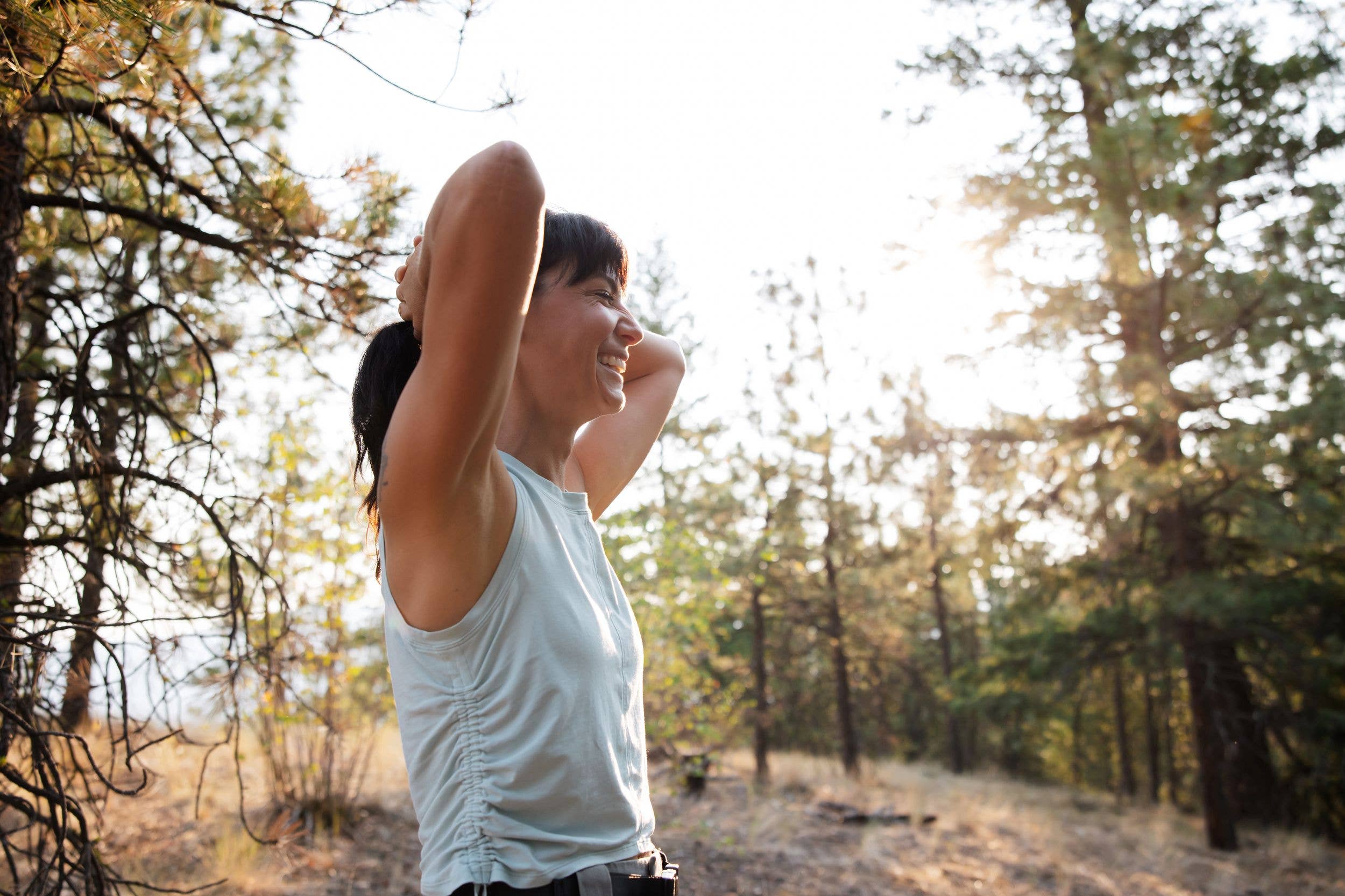 She is tired, sweaty and happy - taking deep breathes after enjoying a hard trail run.