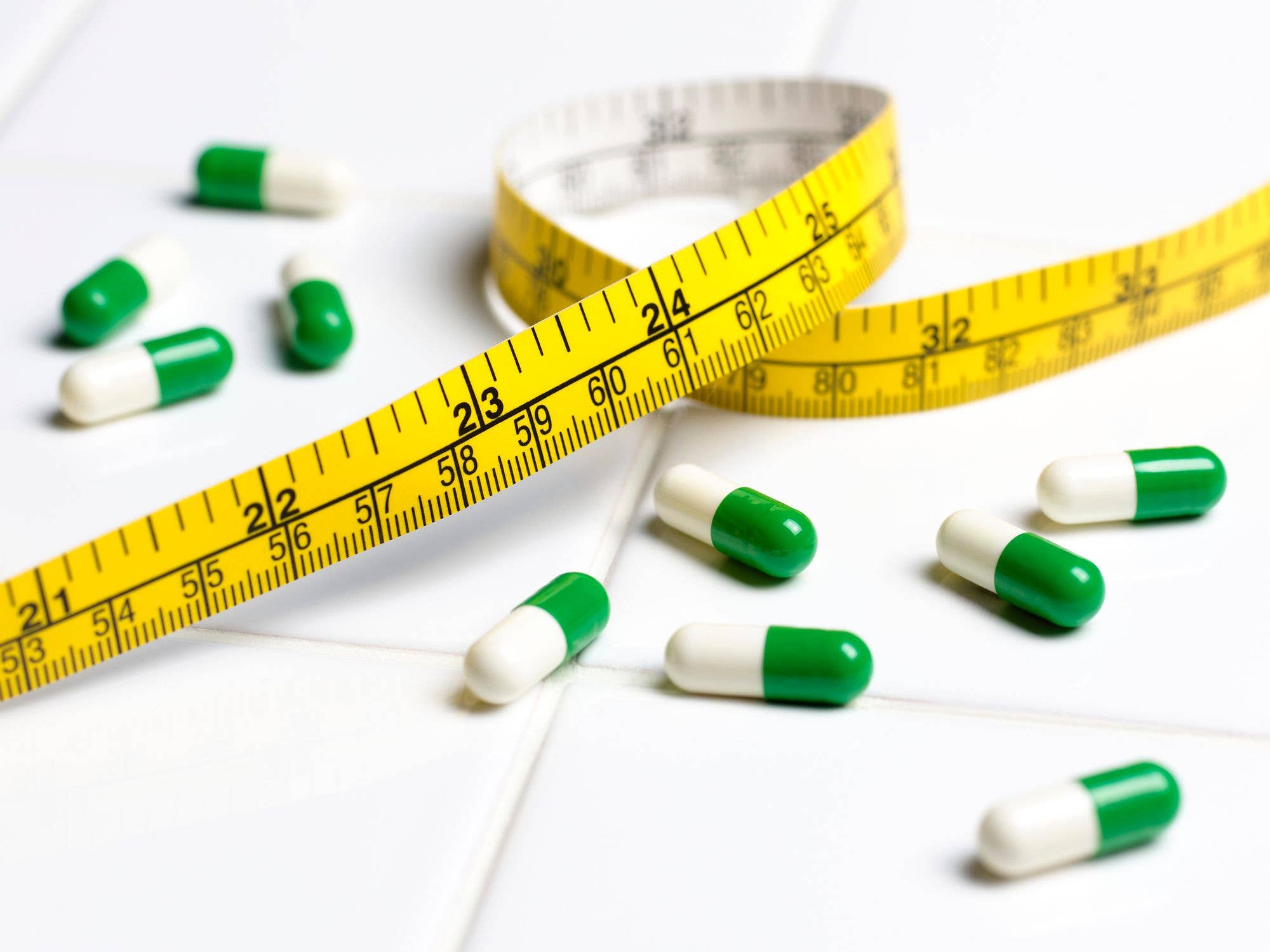 pills with tape measure stock image