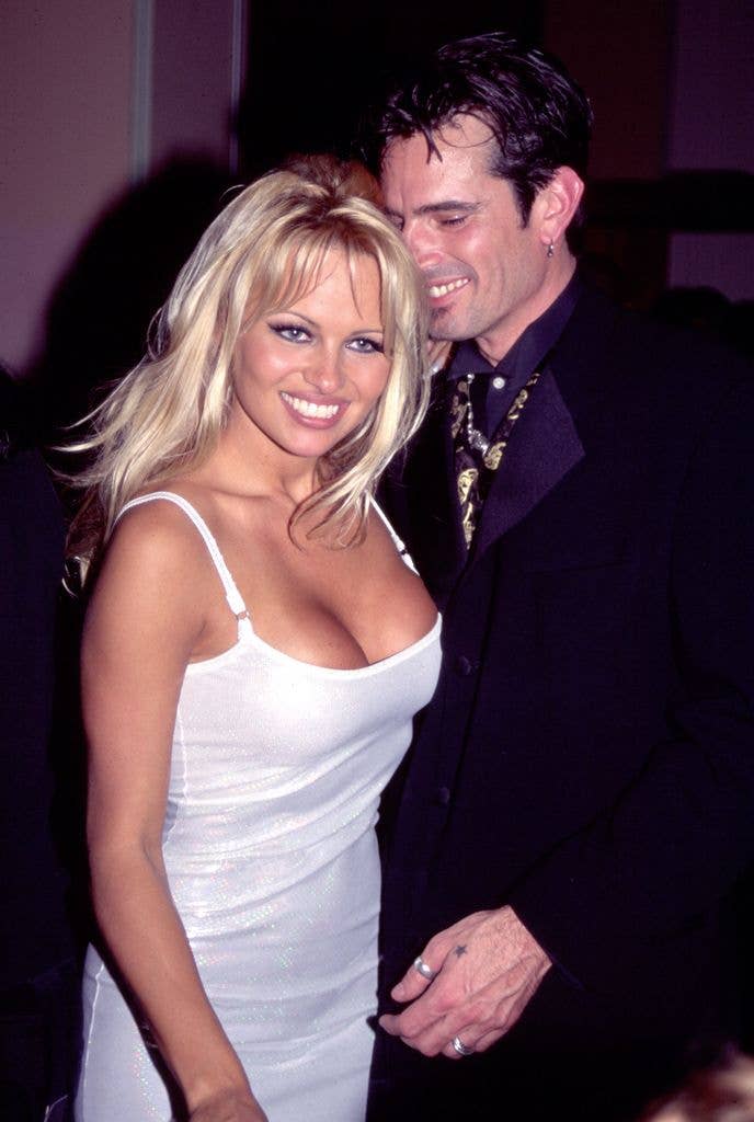 View of married couple, actor & model Pamela Anderson wearing a white dress and Rock musician Tommy Lee wearing a black suit (born Thomas Lee Bass), as they attend Atlantic Records' post-Grammy party at the Parkinson Building