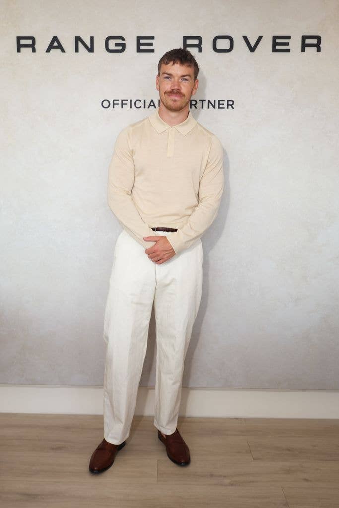 A photo of Will Poulter wearing a cream outfit 