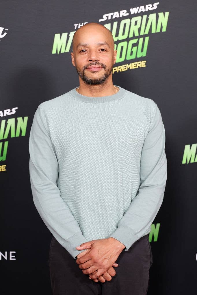 Donald Faison wearing a blue jumper at a premiere 