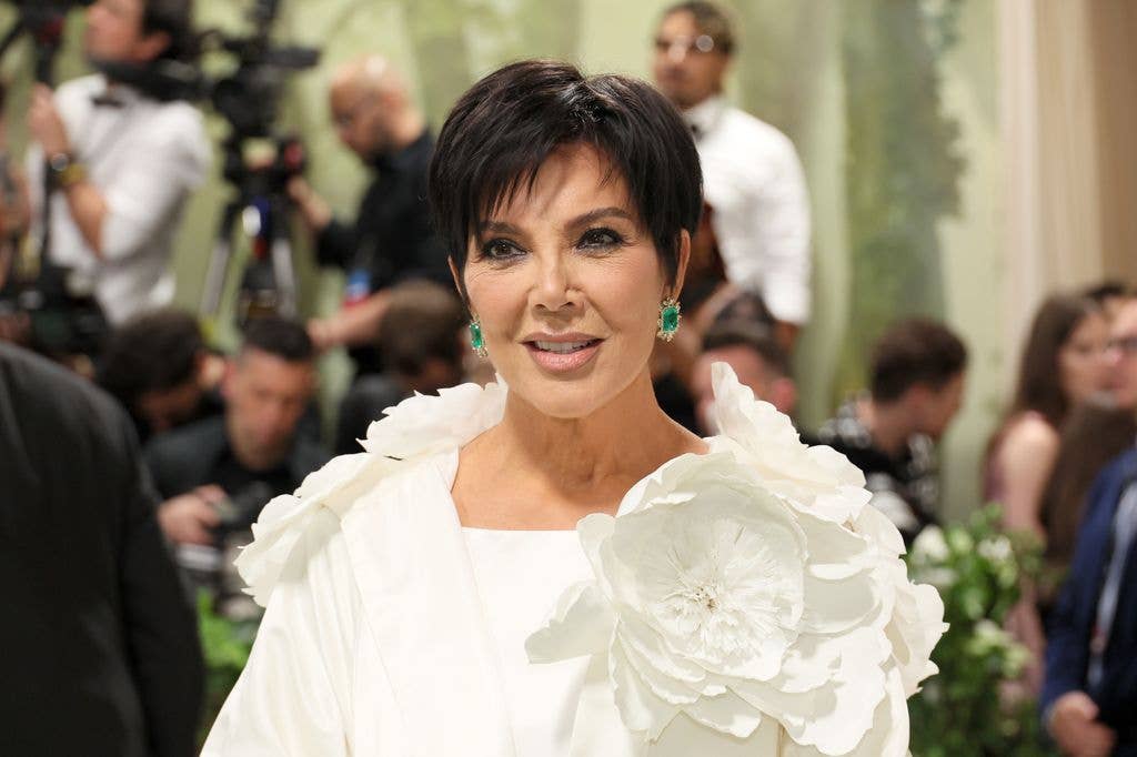 Kris Jenner looking annoyed in a white top