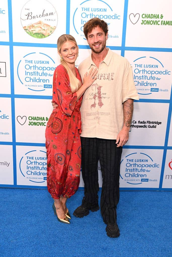 AnnaLynne McCord and Danny Cipriani smiling and posing together at an event.