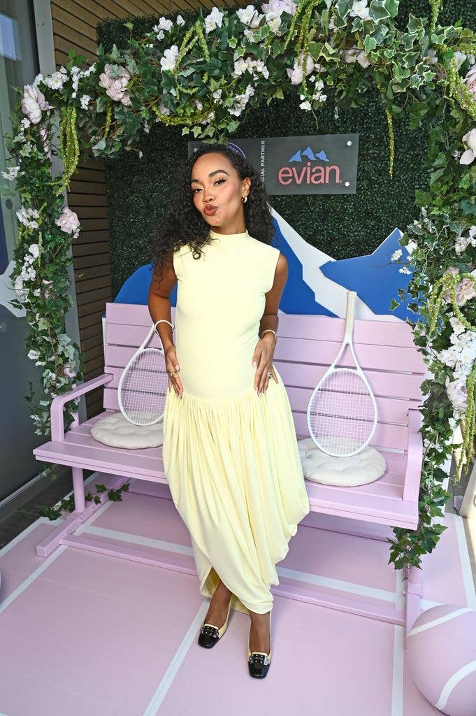 A photo of Leigh Anne Pinnock wearing a yellow dress 