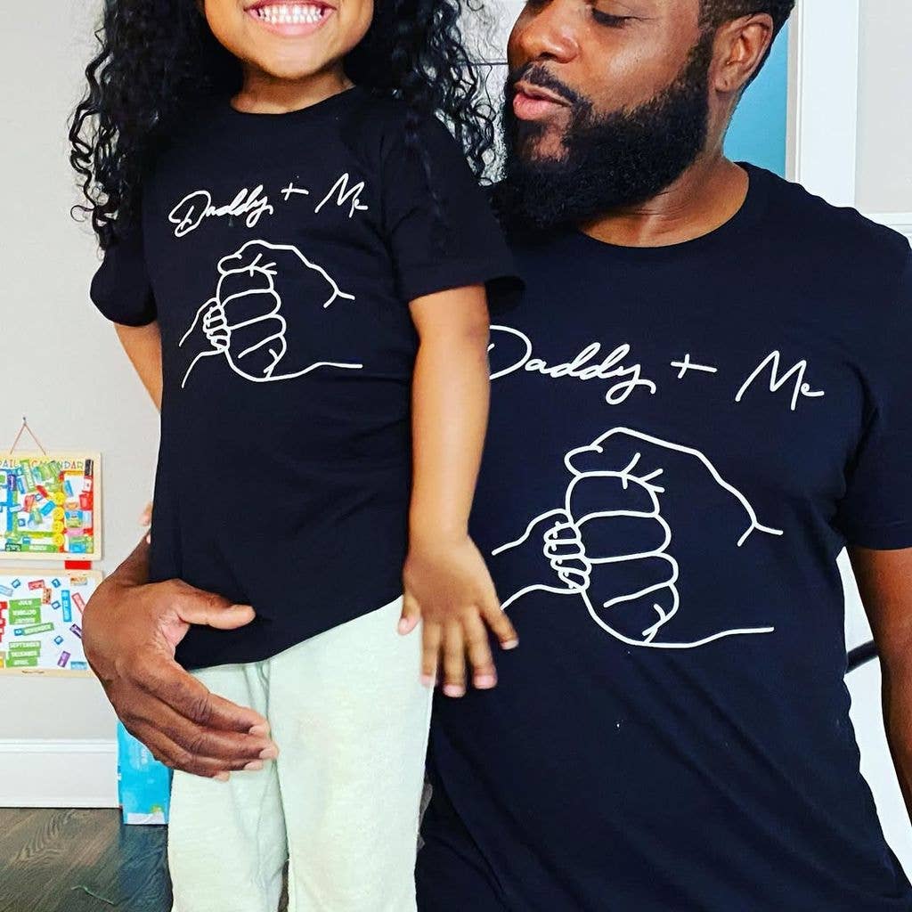 Malcolm with his beaming daughter wearing matching t shirts