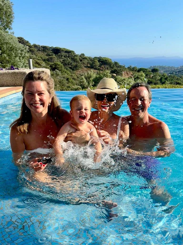 Joan Collins splashes in the pool