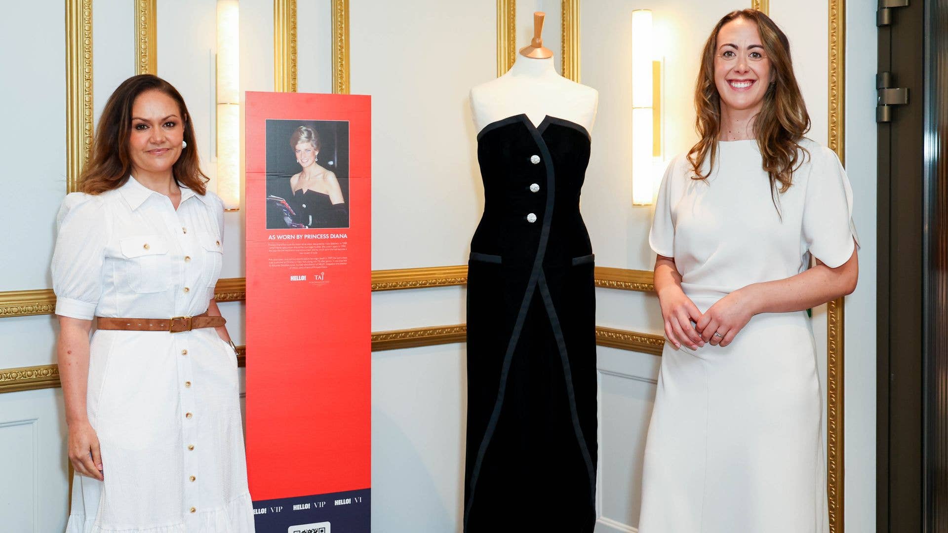 Podcast hosts Emily Nash and Andrea Caamano pose with Princess Diana's dress at our exclusive live recording