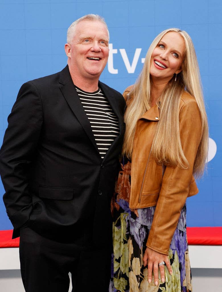 Anthony Michael Hall and partner Lucia Oskerova stand arm in arm at a screening of Ted Lasso.