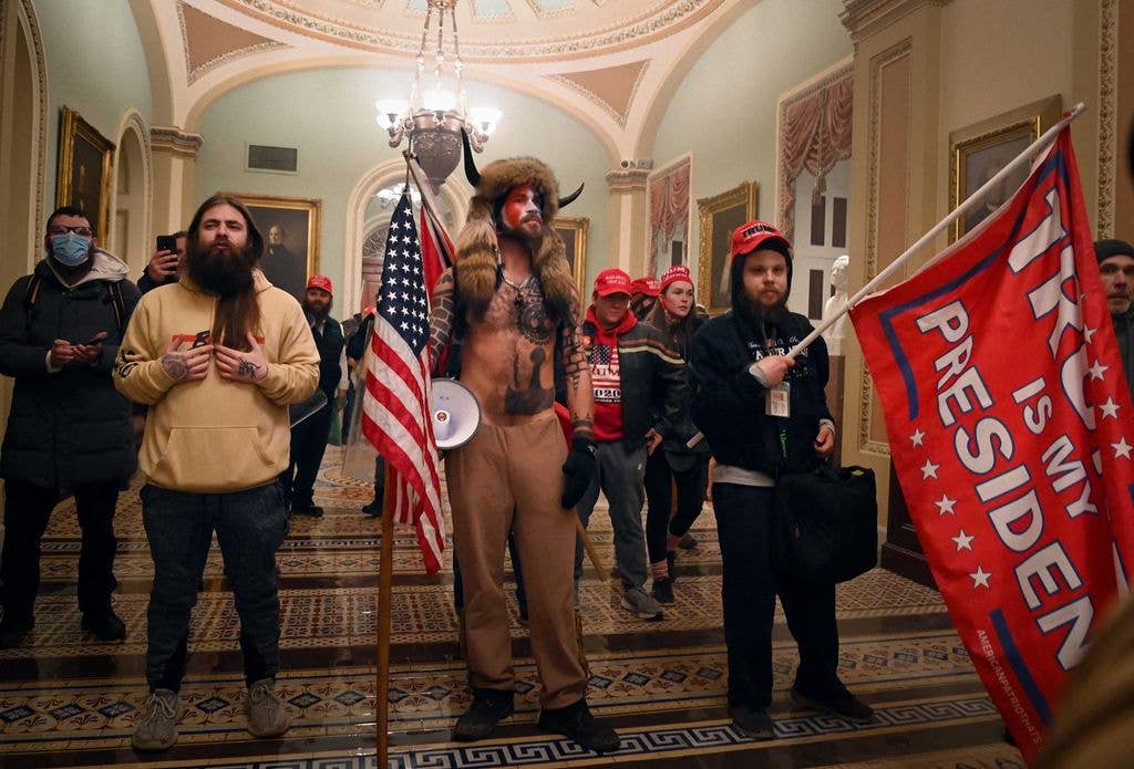 Supporters of US President Donald Trump, including member of the QAnon conspiracy group Jake Angeli, aka Yellowstone Wolf (C), enter the US Capitol on January 6, 2021, in Washington, DC.