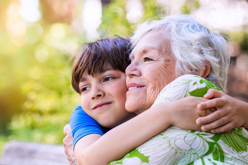 grandson hugging elderly grandmother