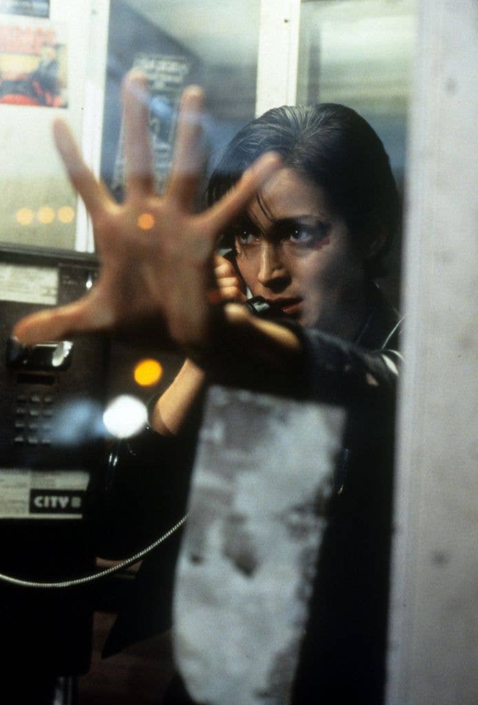 Carrie-Anne Moss in phone booth in a scene from The Matrix, 1999.