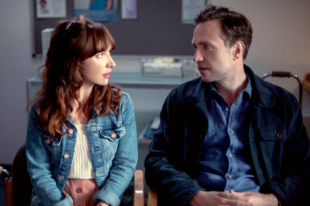 woman and man sitting in office