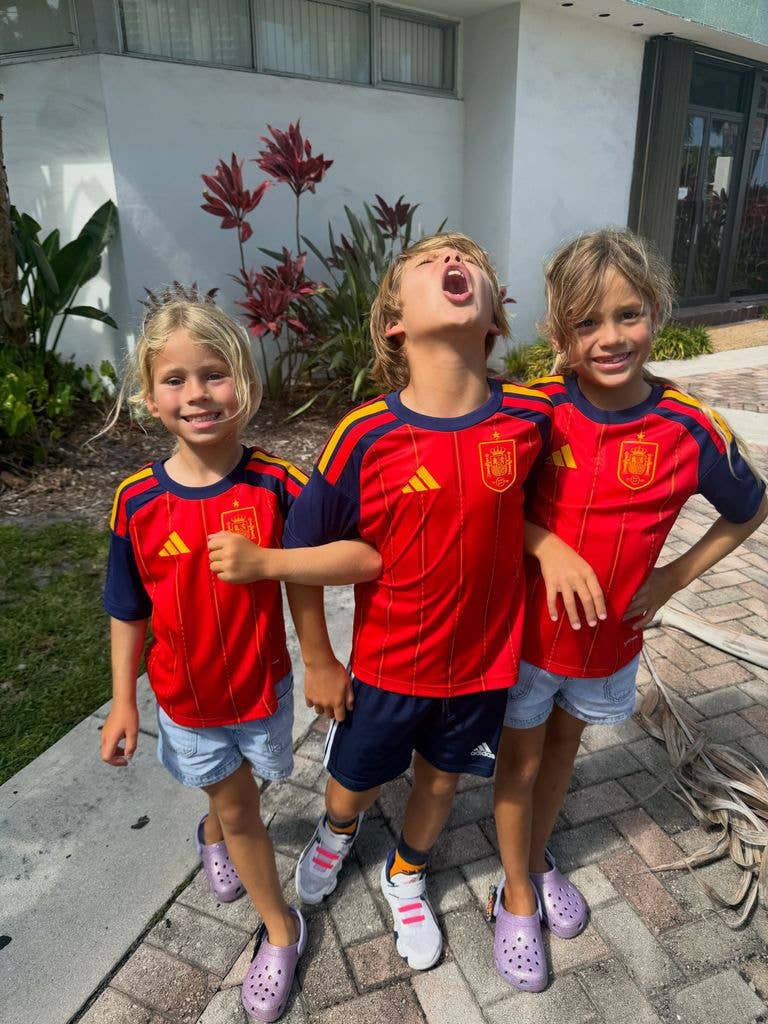 Enrique Iglesias and Anna Kournikova's kids Mary, Lucy and Nicholas pose for a photo in matching Spanish football jerseys after Spain's 2026 FIFA World Cup win, shared on Instagram in July 2026