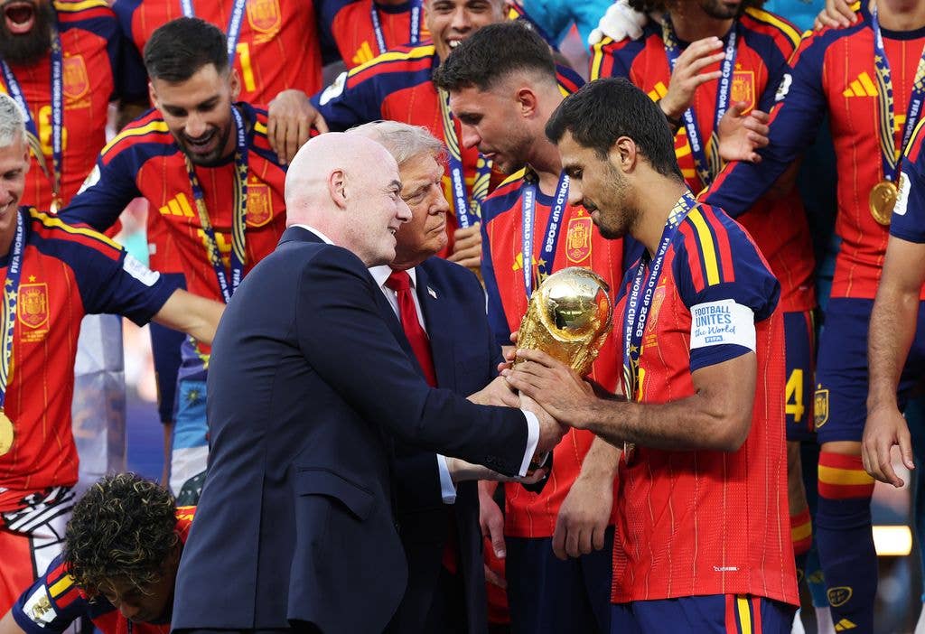 Rodri #16 of Spain is presented the FIFA World Cup Winners Trophy by U.S. President Donald Trump and FIFA President Gianni Infantino