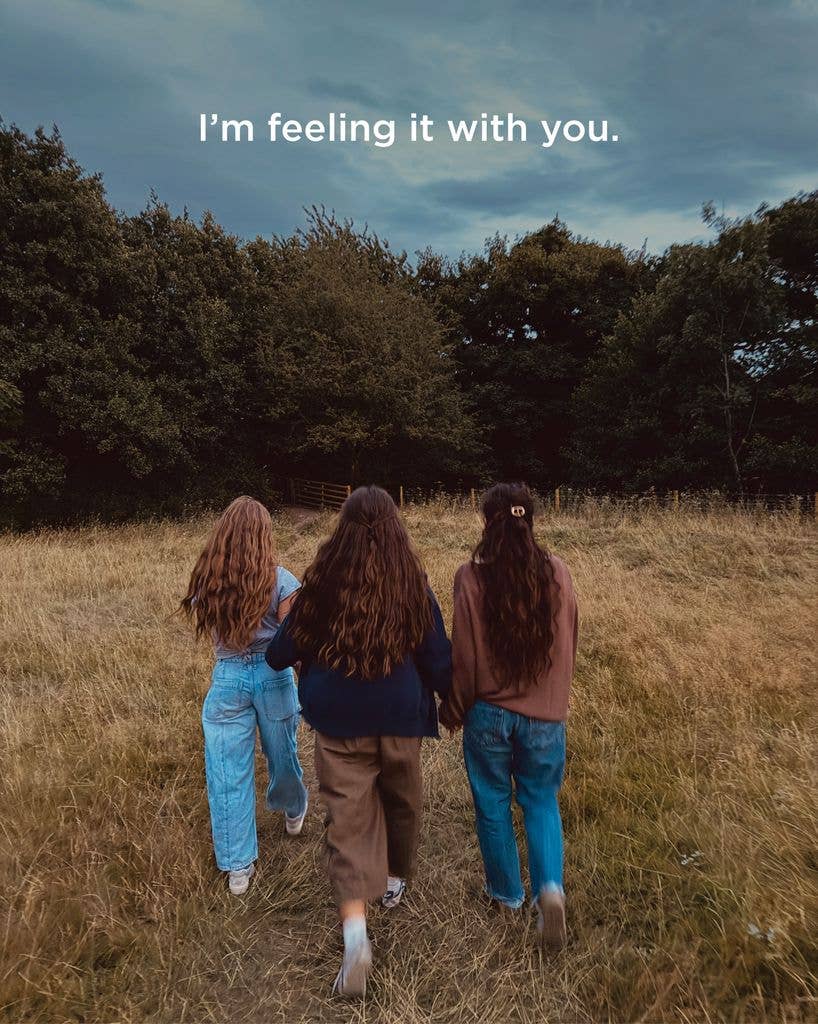 Joanna Gaines holds hands with her daughters Ella and Emmie Kay while walking through a field, shared on Instagram
