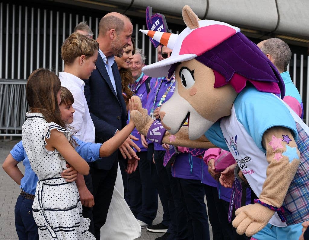 Charlotte waved at the mascot before reaching up to give an excited high five