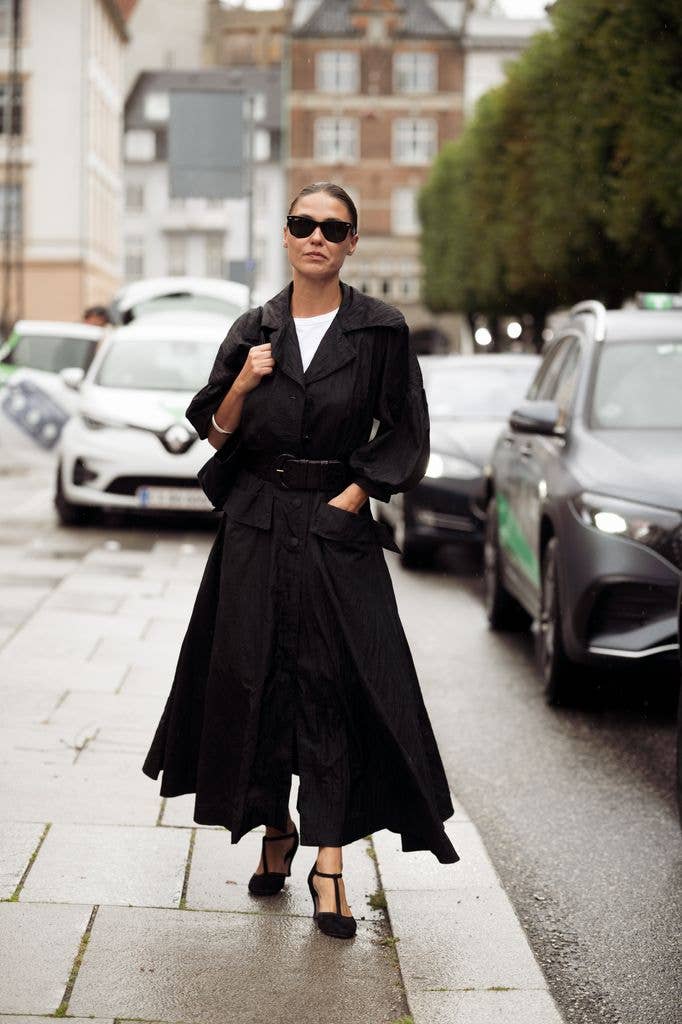 Sophia Roe wears white top, black long maxi dress with a belt, black sunglasses and a black pointy high heels outside MKDT show during the Copenhagen Fashion Week Spring/Summer 2027 on August 04, 2026 in Copenhagen, Denmark. (Photo by Raimonda Kulikauskiene/Getty Images)