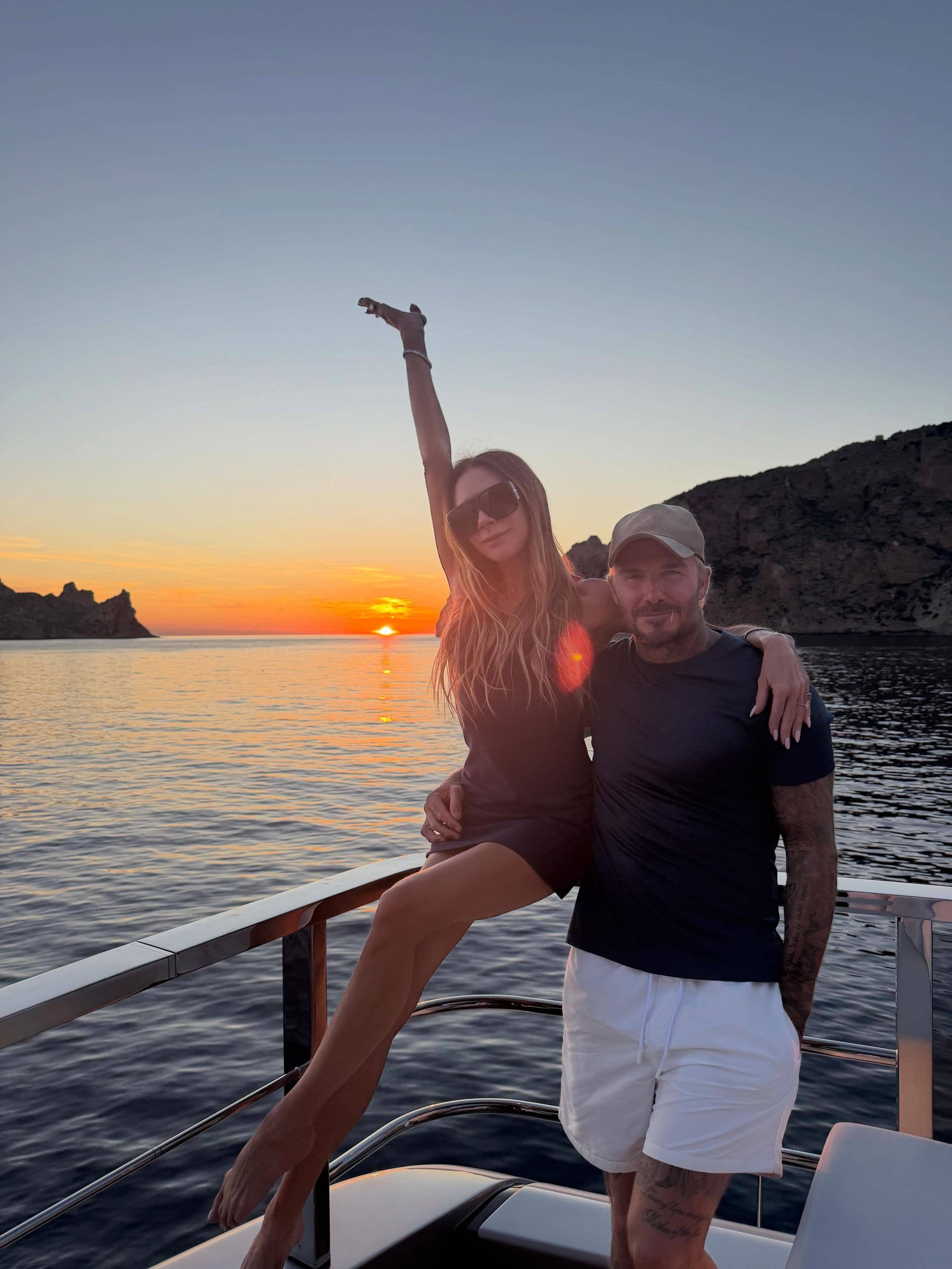 David and Victoria Beckham on yacht deck at sunset