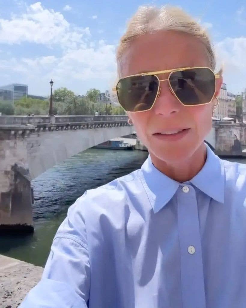 Screengrab of Gwyneth Paltrow's first TikTok; she stands on a street with a bridge behind her
