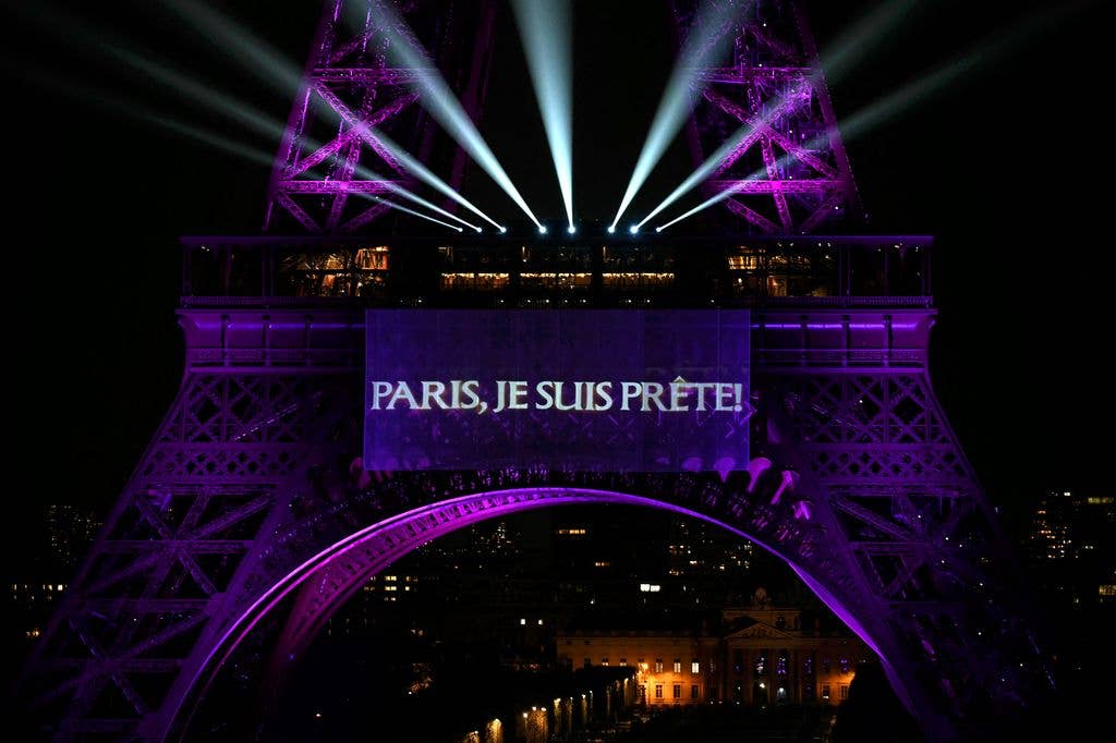 This photograph shows the slogan "Paris, I'm ready" projected onto the Eiffel Tower as Canadian singer Celine Dion announces a series of concerts in the French capital marking her return after six years away from the stage, in Paris, on March 30, 2026.