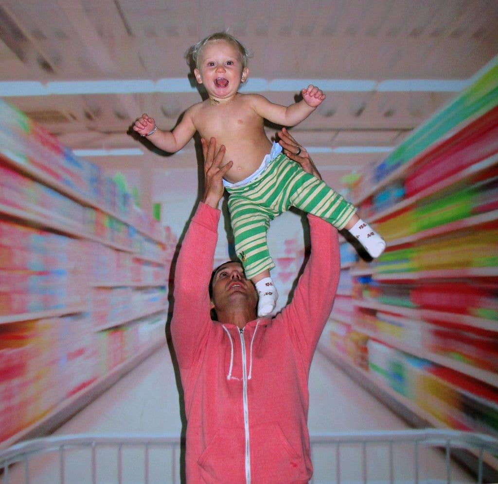 Gavin Rossdale holding baby son Zuma in the air