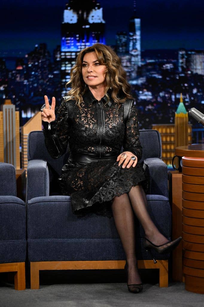 Shania Twain in black leather outfit sitting down on Jimmy Fallon show
