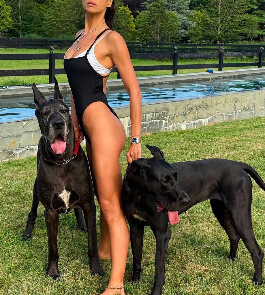 Irina Shayk posing in a swimsuit with dogs