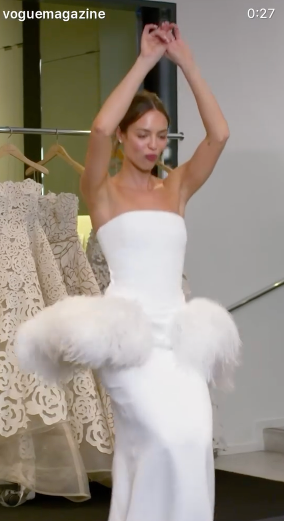 Claudia changed into a structured cady gown with a statement sculptural peplum fashioned from upcycled feathers