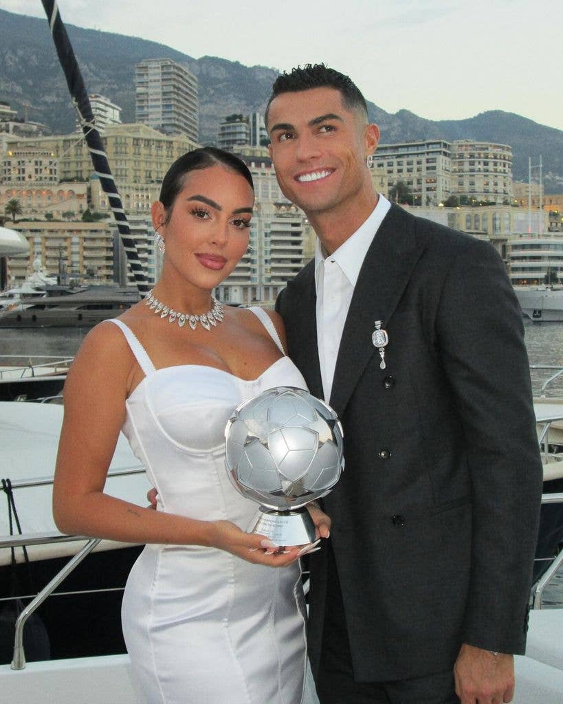 Georgina Rodriguez and Cristiano Ronaldo pose for a photo with his football trophy on a boat, shared on Instagram