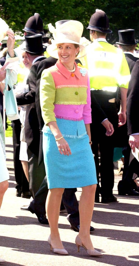 Sophie, Countess of Wessex, wearing a colorful jacket and blue skirt, smiles among a crowd.