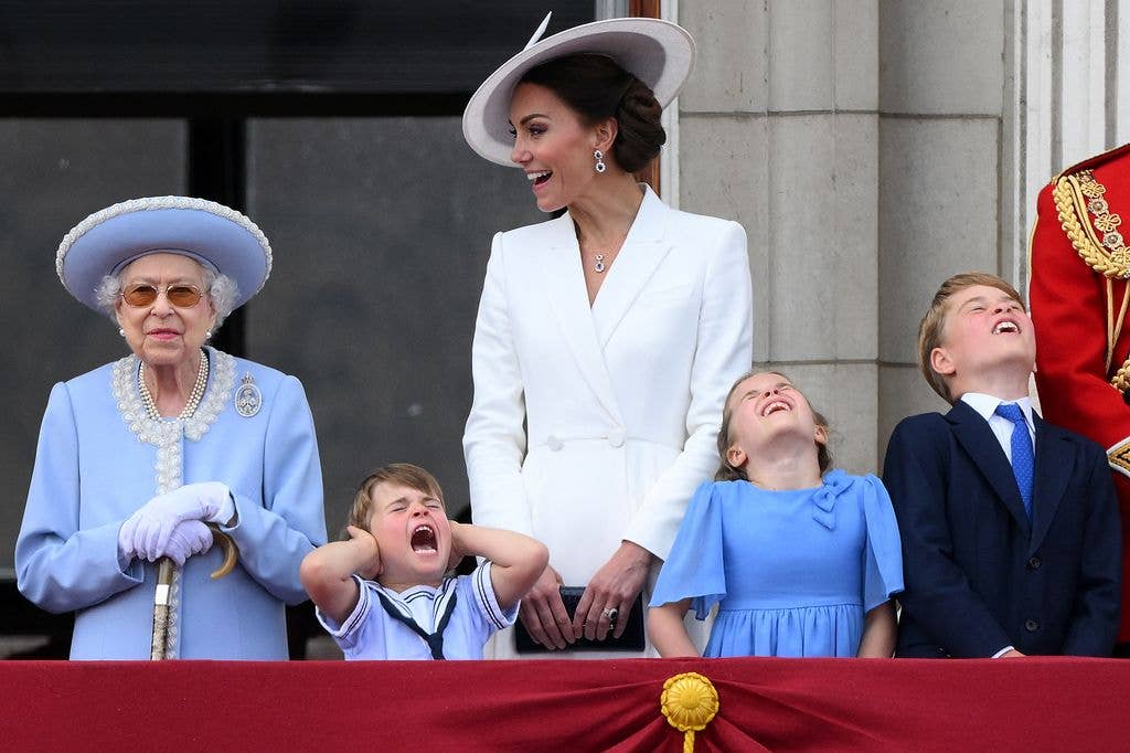 Britain's Prince Louis of Cambridge (2L) holds his ears as he stands next to Britain's Queen Elizabeth II (L), his m mother Britain's Catherine, Duchess of Cambridge (C), Britain's Princess Charlotte of Cambridge (2R)and Britain's Prince George of Cambridge to watch a special flypast from Buckingham Palace balcony following the Queen's Birthday Parad