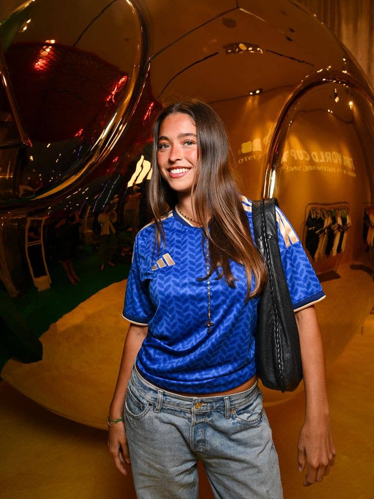Lola wearing a soccer jersey and jeans