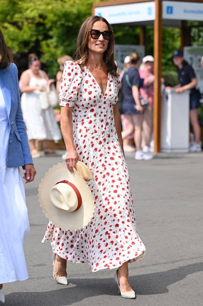 Pippa Middleton wears a white and red polka dot midi dress with straw hat