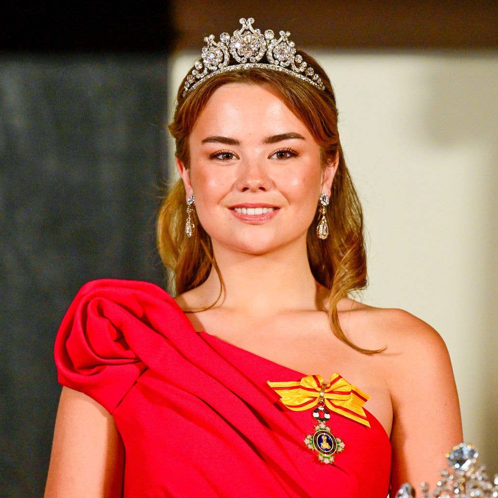 Princess Ariane smiling in a diamond tiara and red dress