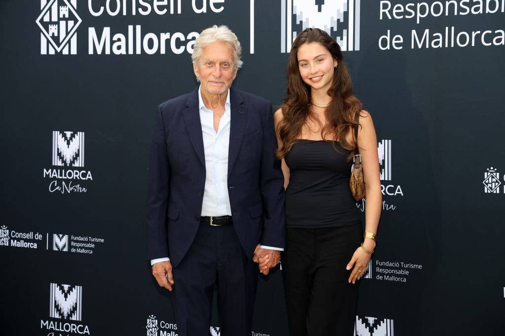 The father-daughter duo smiled for photographers before affectionately holding hands