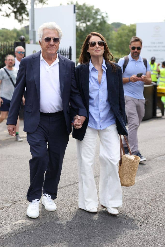 Dustin Hoffman and his wife holding hands in matching Ralph Lauren outfits