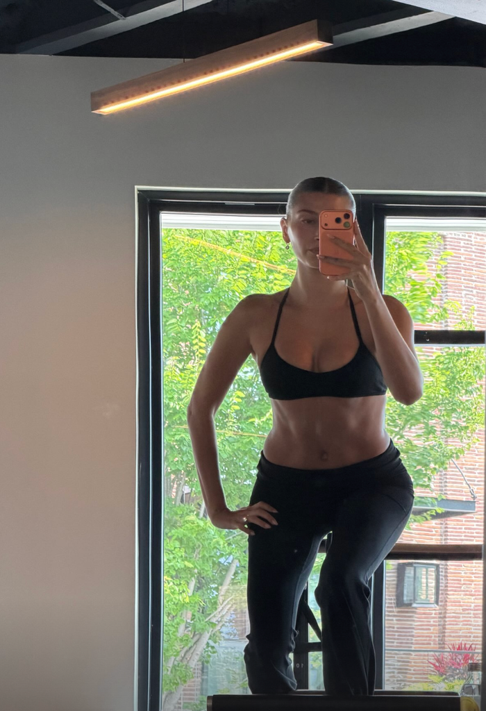 Hailey also sahred a photo of hersedlf on a reformer pilates bed 