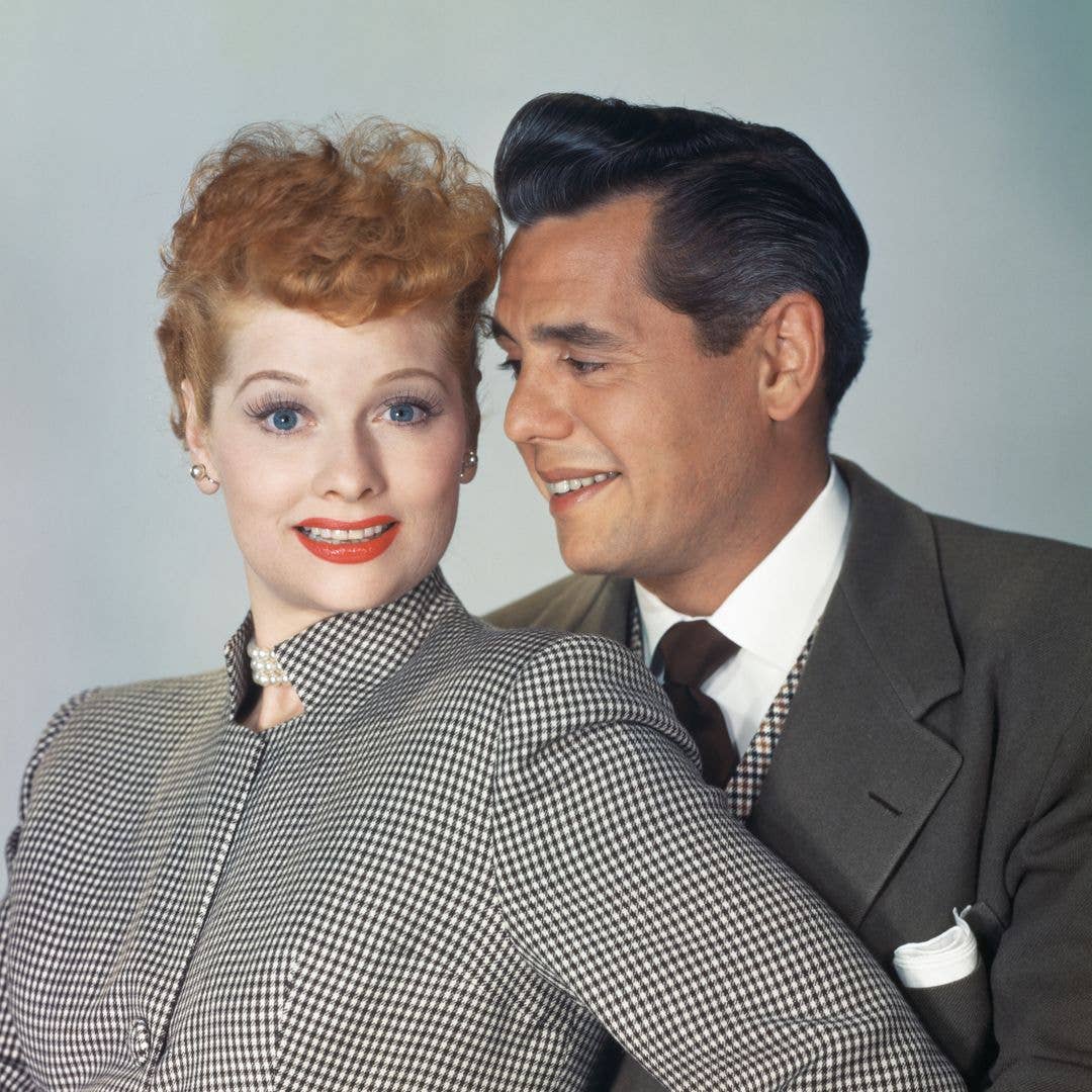 American actress and comedian Lucille Ball, wearing a black-and-white checked high collar outfit with a pearl choker, beside her husband, Cuban-born American actor, musician and comedian Desi Arnaz, in a publicity portrait for their sitcom 'I Love Lucy', United States, circa 1953